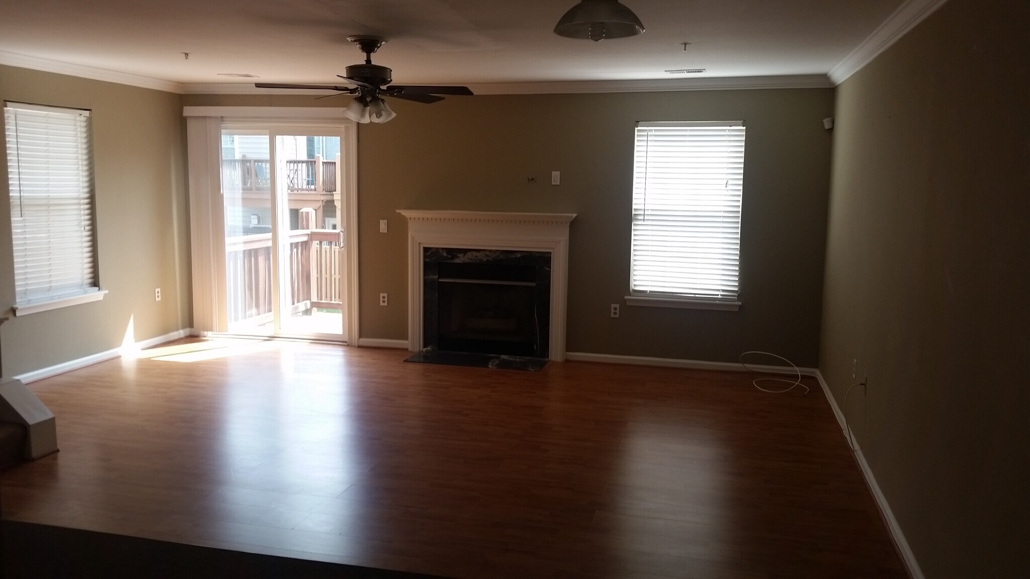 Beautiful living room with pergo flooring, natural/neutral wall colors and crown moulding - 2469 Wentworth Drive