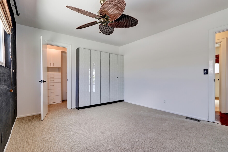In addition to the closet, another cabinet provides loads of storage in the primary bedroom. - 744 12th St