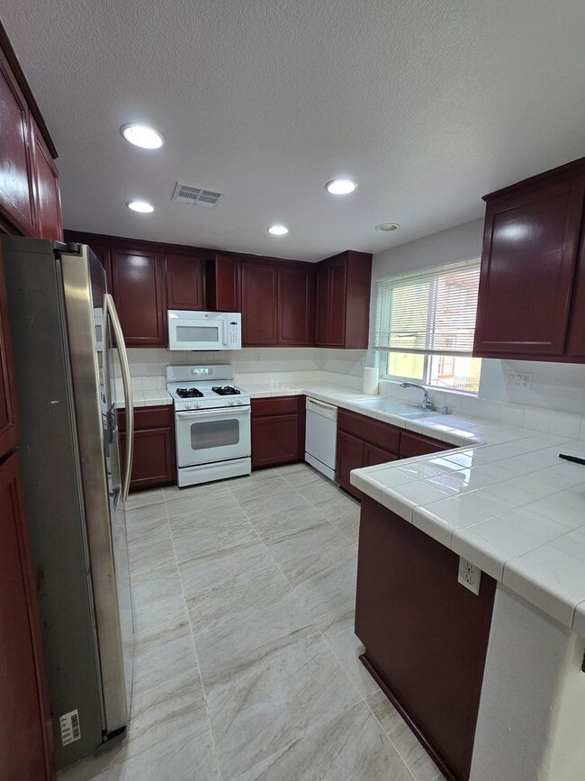 Building Photo - Beautifully Remodeled Tri Story Home located in a Gated Community ...