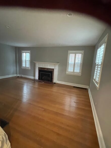 Spacious living room with modern gas fireplace freshly painted and refinished - 7819 12th St NW