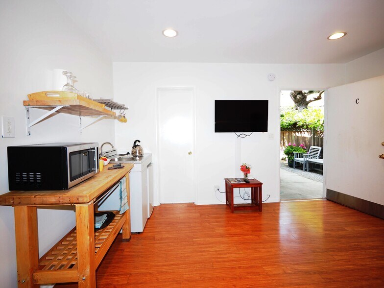 Facing TV wall, bathroom door, front door; rent includes ALL utilities - 828 7th St