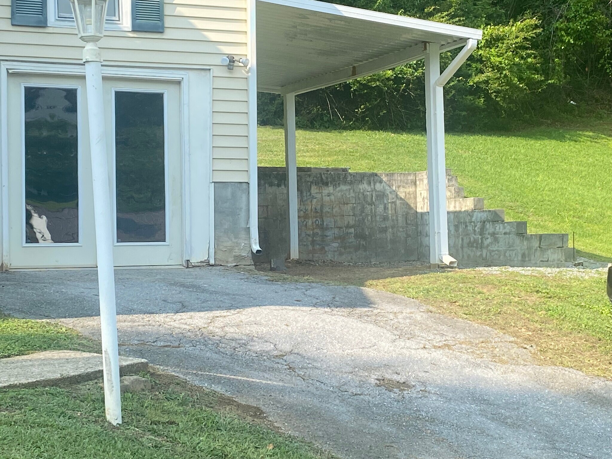 The unfinished storage entrance and one car covered parking - 776 Valley Dr