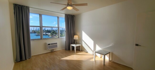 Bedroom with ceiling to floor sheer and blackout curtains. - 3 Island Ave