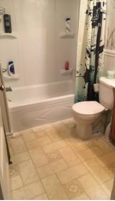 Bathroom with tub and shower. New flooring and vanity coming soon - 432 E 7th St