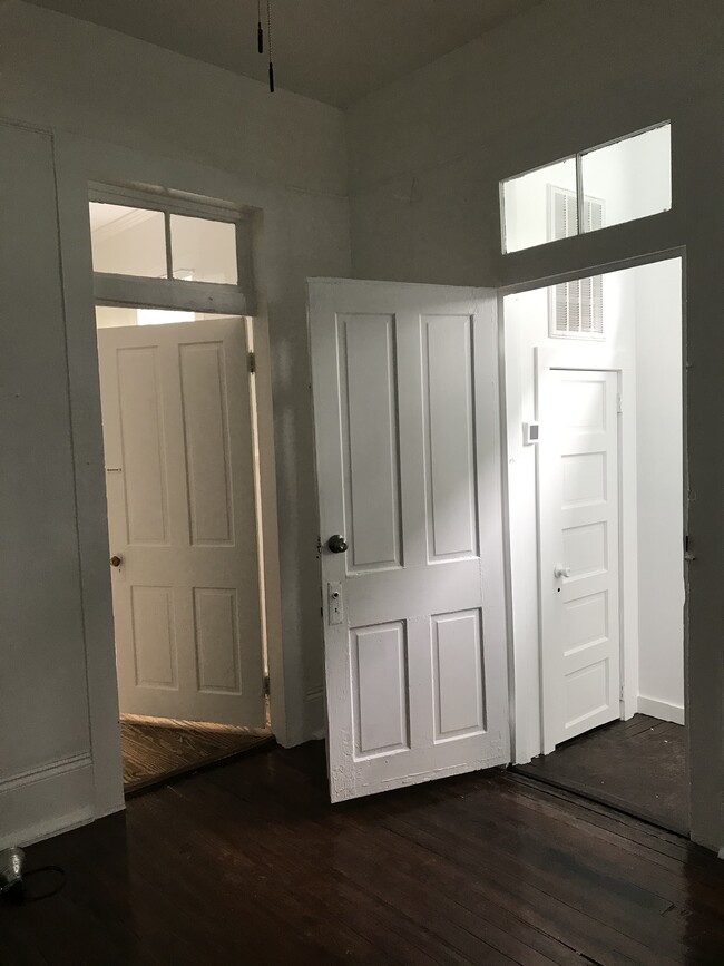 From first room - doors to front entry, side hall and second room - 2214 Valence St