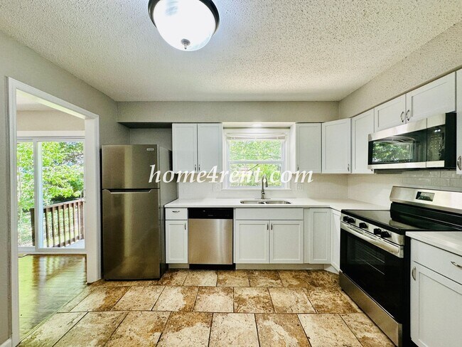 Building Photo - Updated Raytown Ranch w/ Wood Floors, SS Appliances, Finished Basement and a Fenced Yard!