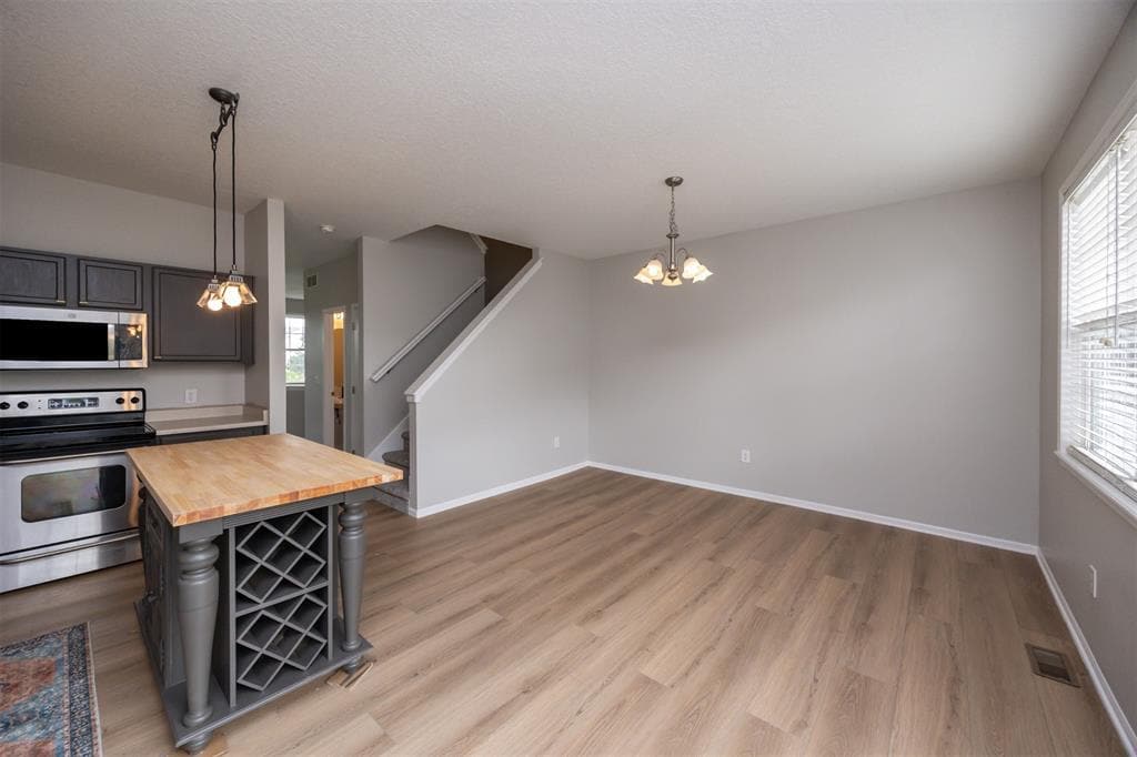 Kitchen: Countertops are now hard stone and faucet is matte black - 928 NE Kamies Ln
