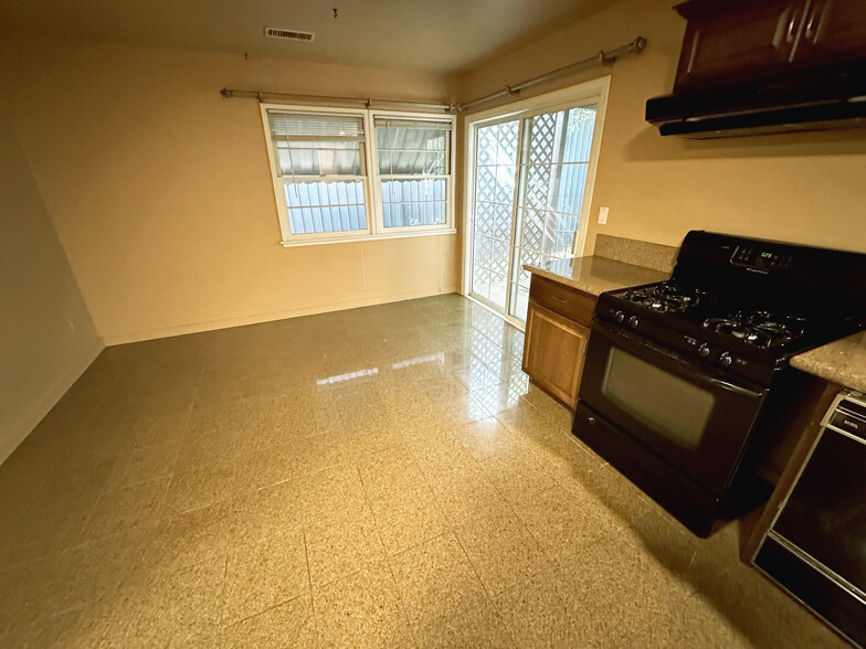 Kitchen sink, dish washer, stove, and dining area - 10809 Huston St