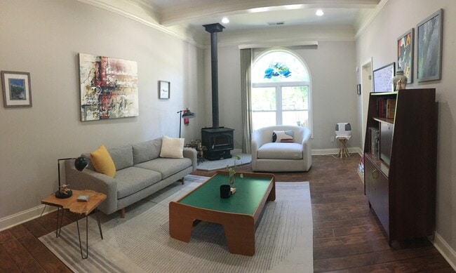 Wood-burning stove and picture window in living room - 809 Braselton Hwy