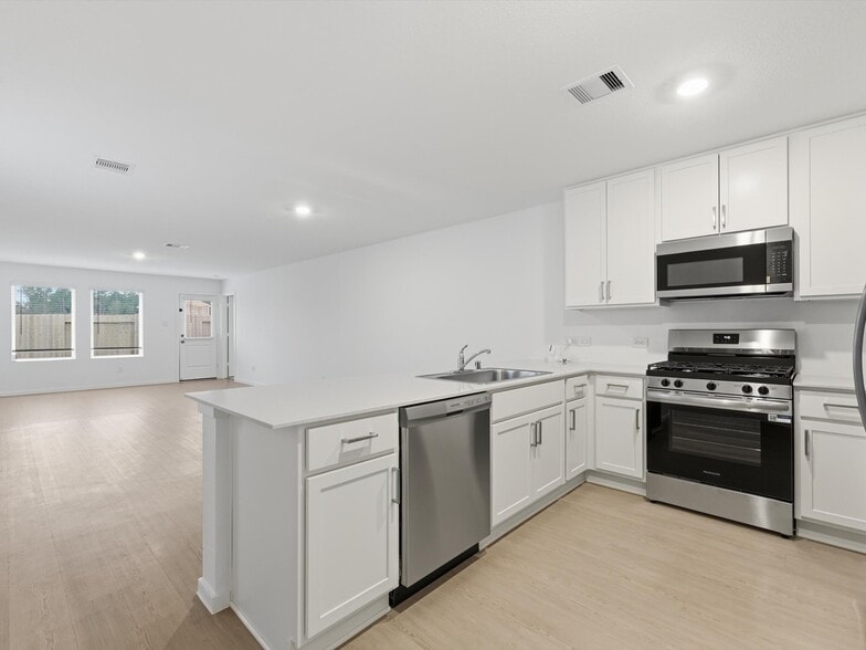 Kitchen opens to the living space - 25409 Carnation Ct