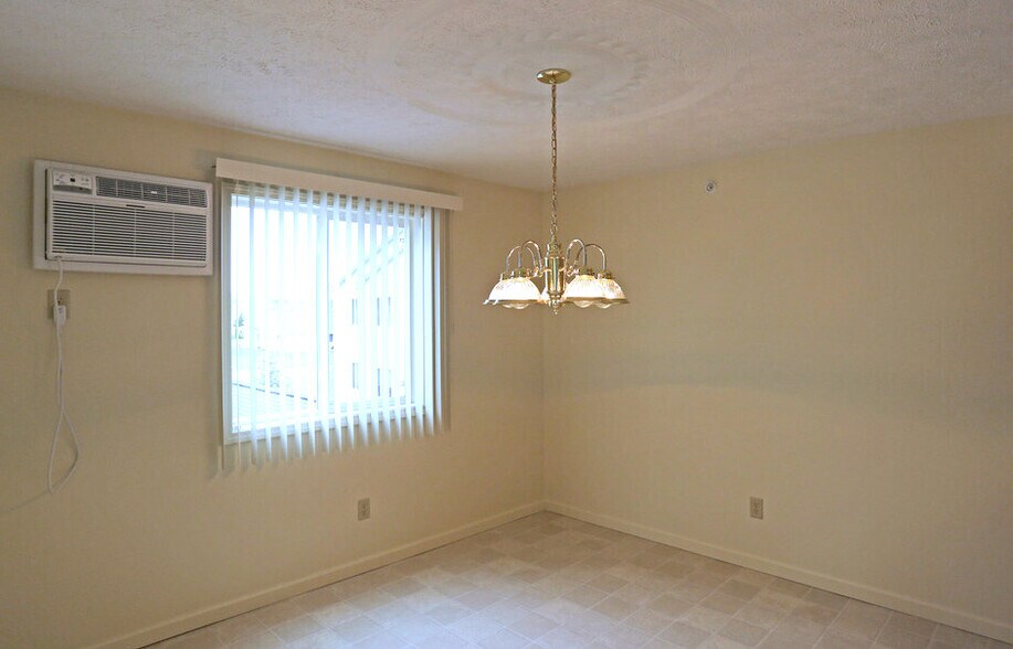 One Bedroom - Dining Area with Air Conditioning Unit - New Country Village Apartments