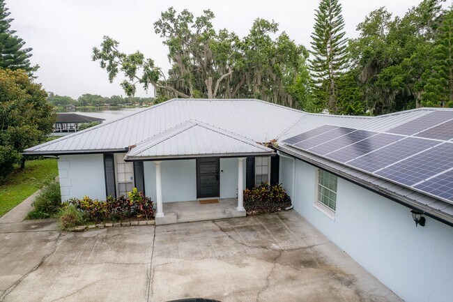 Building Photo - Lake Jessamine Luxury: Solar-Powered Waterfront Retreat on 1.14 Acres with Dock & Boathouse