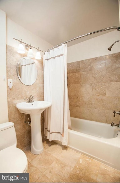 Newly renovated bathroom with tiled floors and walls - 3719 12th St NE