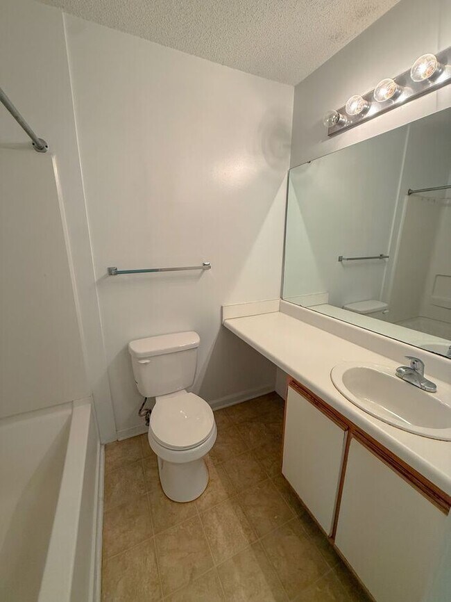 Building Photo - Top floor 4 bed 4 bath condo! On Wolfline, perfect for roommates!