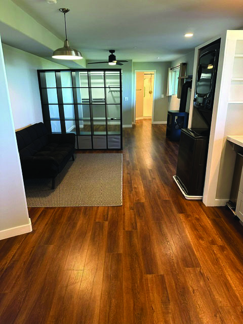 View from kitchen looking toward bathroom at far end of studio apartment. - 7079 Engineers Rd