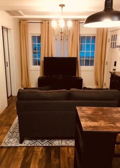 Living room with smart TV and blackout curtains - 510 Auburndale Ave