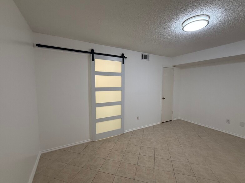 Barn door to bathroom. - 2301 Basil Dr