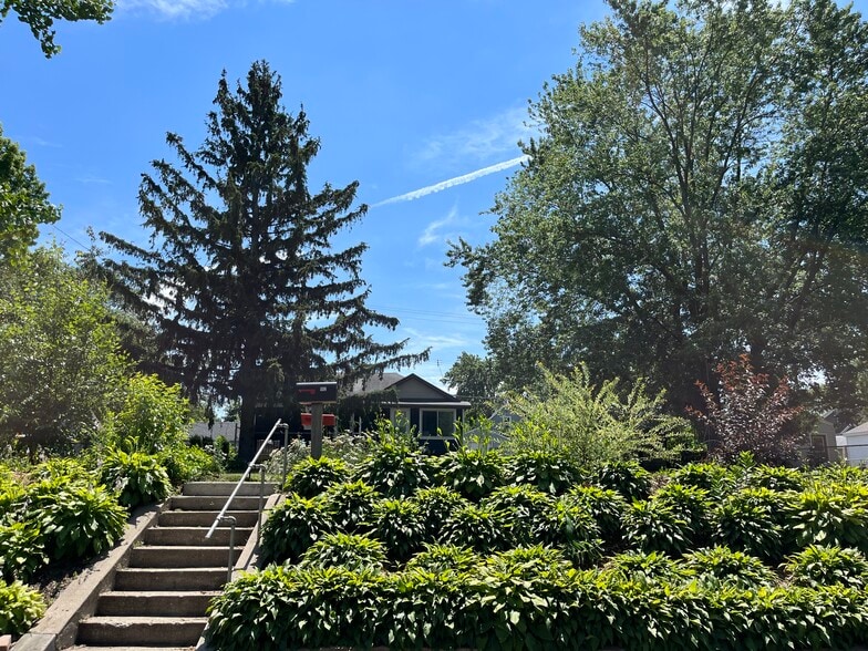 View from the street to the house set in the back of the proper - perennial landscaping and privacy. - 1012 Englewood Ave
