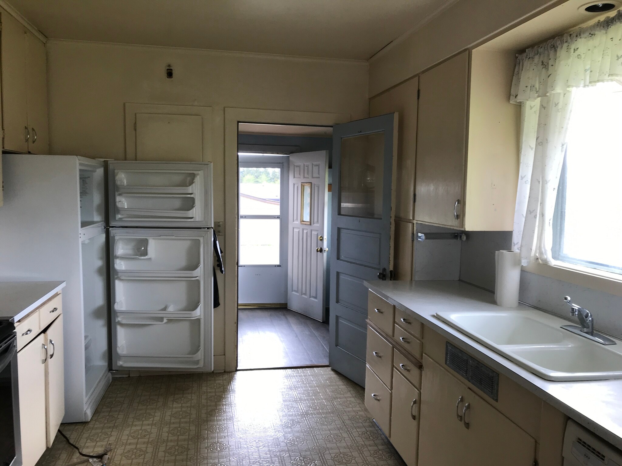 Kitchen leads to back door & carport and laundry - 615 W Main St