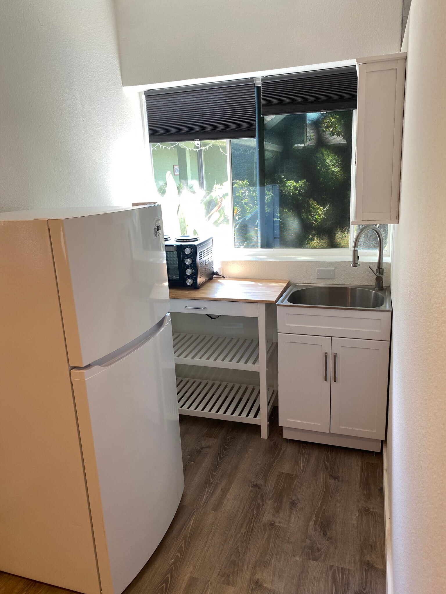 Kitchenette with convection oven and two burners, large sink, refrigerator, shelves and cabinet - 136 Farallon Dr