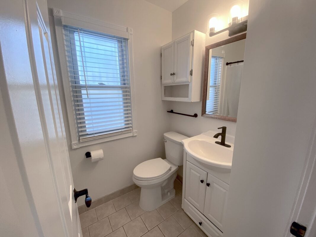 Bathroom - New toilet and modern fixtures and tile flooring - 710 Sheridan Avenue North