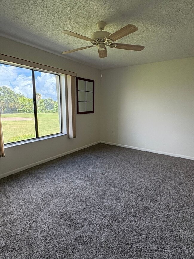 Building Photo - (55+) 2/2 Condo in the Peaceful Miles Grant Golf Course Community