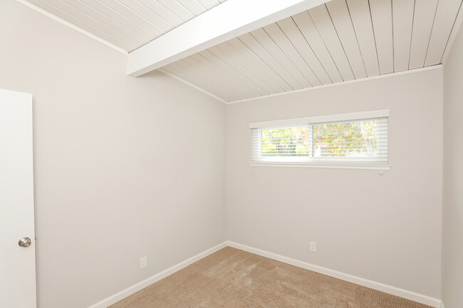 Second bedroom with vaulted ceilings, double pane window, newer carpet - 3321 Alma St