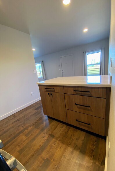 Ample drawer and cabinet space with sleek, light wood finishes for storage. - 575 Greenwood Ave