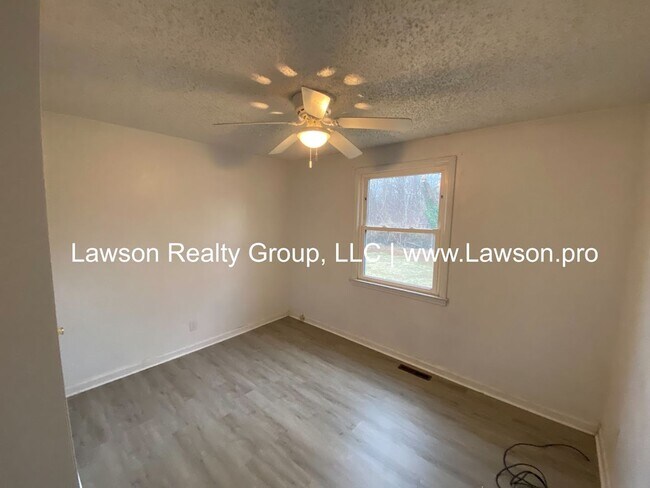 Building Photo - Well Maintained Three Bedroom with Fenced Yard and Shed