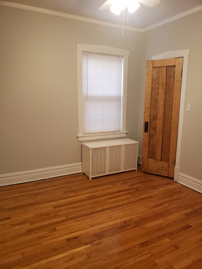 Bedroom #1 freshly painted with hardwood floors - 3811 N Central Park Ave