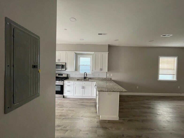 Unit two: brand new open concept kitchen and living/dining space. - 34 Falcon St