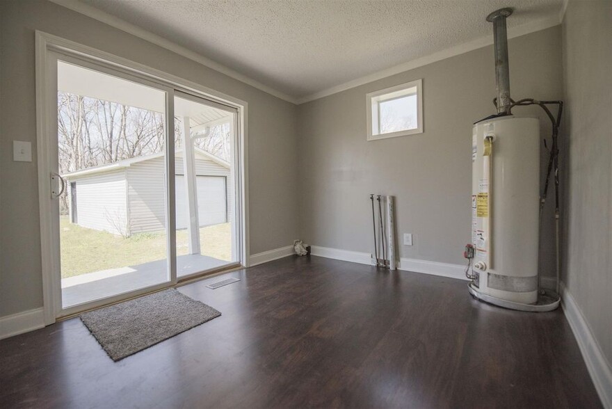 Large Laundry/Utility room with covered porch. Washer and Dryer hookups - 725 North Academy Street