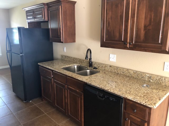 Kitchen with granite counter tops. Refrigerator included if needed. - 107 S Grant St