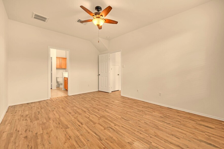 Master bedroom with doors to bath and living room - 9201 Brodie Ln