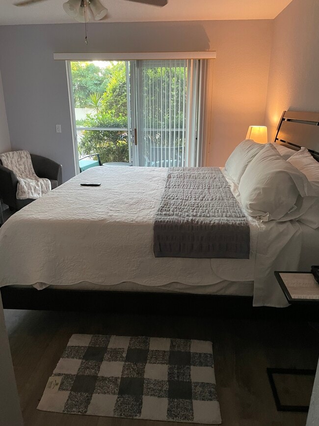 Master bedroom with king bed, 50-inch flat screen and patio. - 850 S Tamiami Trl