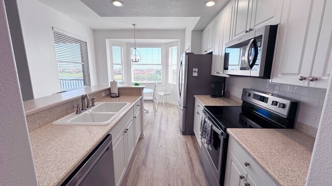 Building Photo - Elevated Luxury at The Terraces – 4th Floor Lake & Golf Course Views! 55+ Community!