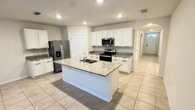 Building Photo - Available NOW! Spacious 4BD/2BA Haven in Villages at Harmony – Your Dream Home Awaits! WASHER & D...