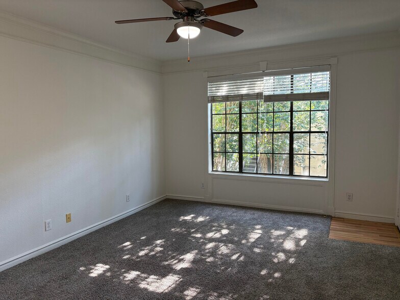 Living room view of trees in apartment complex - 2700 Revere St