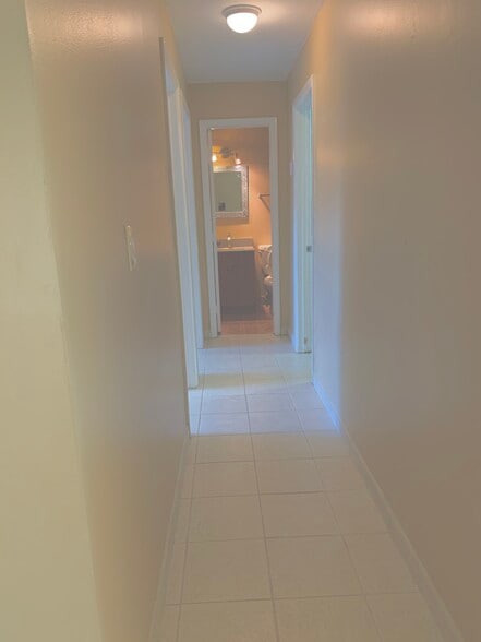 Access Hallway to the Second, Third Bedrooms, Second Bathroom, and Laundry Room Area. - 13566 SW 11th Ln