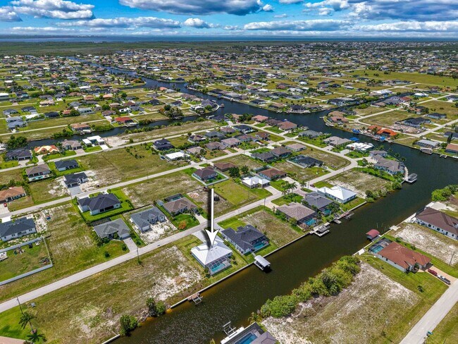 Building Photo - NOW AVAILABLE - Gorgeous Pool Home ~ NW Cape ~ 3 Car Garage ~ On Canal!