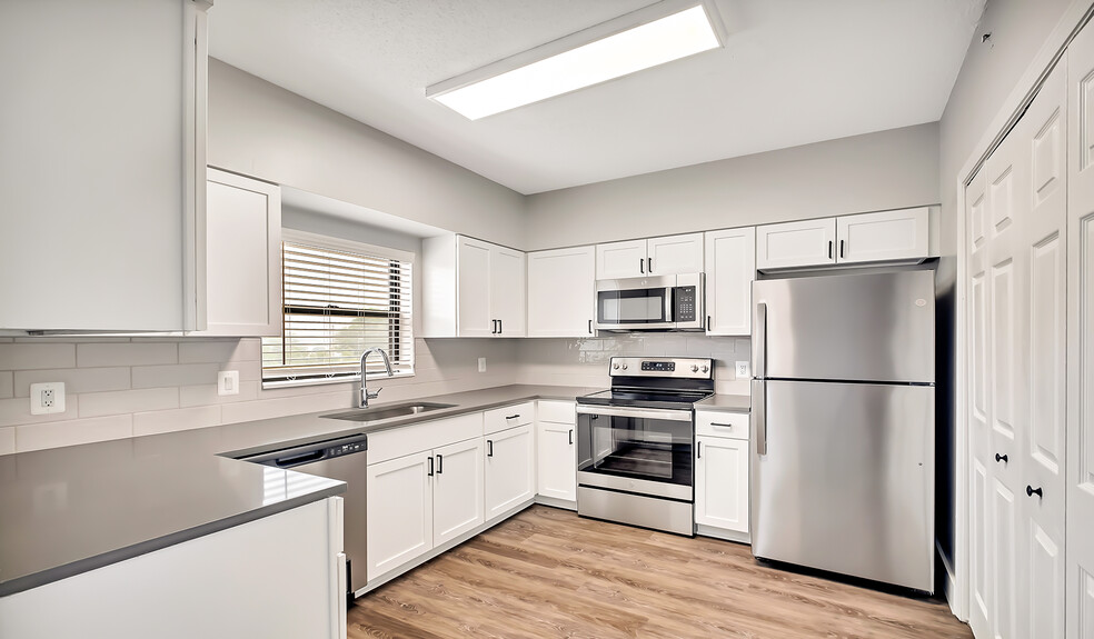 Select homes have upgraded kitchens with quartz countertops and wood flooring - Huntington Gateway