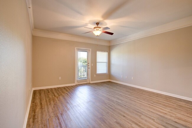 Spacious Living Room with Hardwood-Style Flooring - Carrington at Champion Forest Apartments