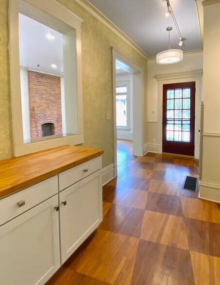 Entry hallway with custom hardwood stained floors. - 1321 Highland St