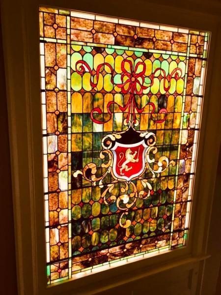 Original stained glass crest off foyer and steps up to second floor - 1049 Franklin Ave