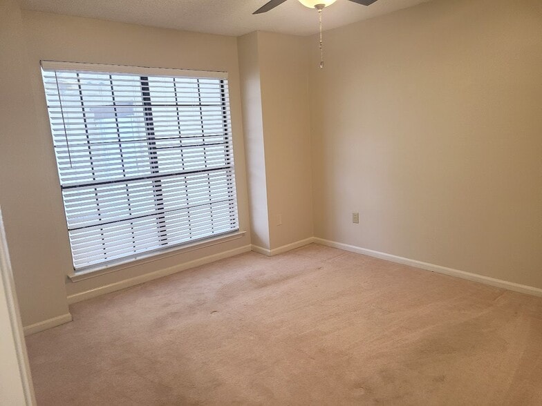 Guest Bedroom #1 with large windows to private patio - 12439 Coursey Blvd