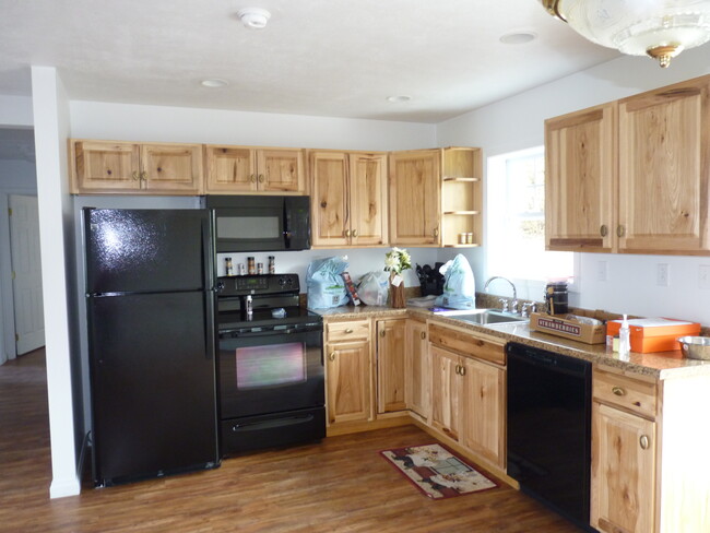 Newer kitchen with refrigerator, stove, microwave, dishwasher - 1190 Ross Ave