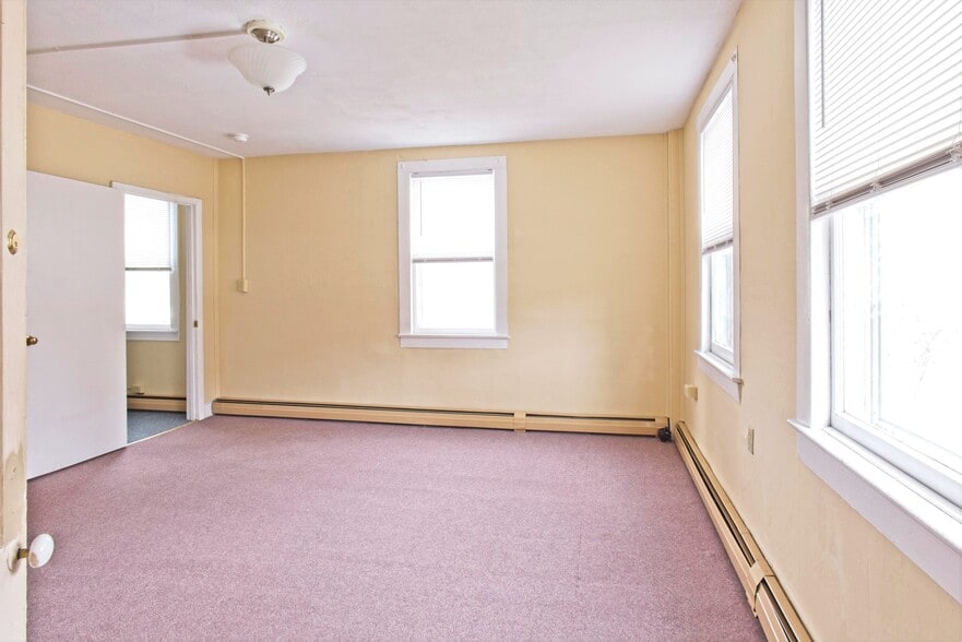 Large bedroom looking towards living room - 100 N Main St