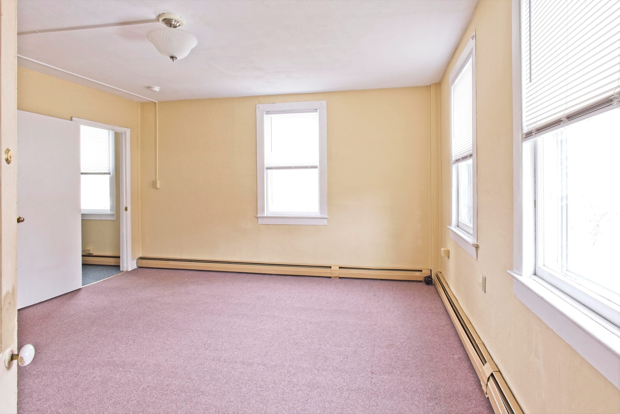 Large bedroom looking towards living room - 100 N Main St