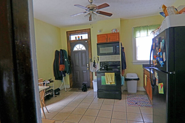 Large eat in kitchen seen from hallway with view of rear entry door - 372 E Oakland Ave