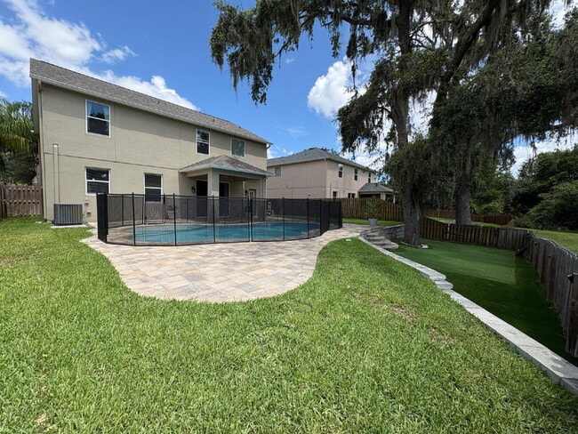 Building Photo - Spacious 5-Bedroom Pool Home with Putting ...